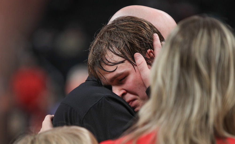 <p>Senior guard Isaac Andrews hugs his father after losing to Brownstown Central March 30 at Gainbridge Fieldhouse. Andrews won the Mental Attitude Award. Andrew Berger, DN</p>