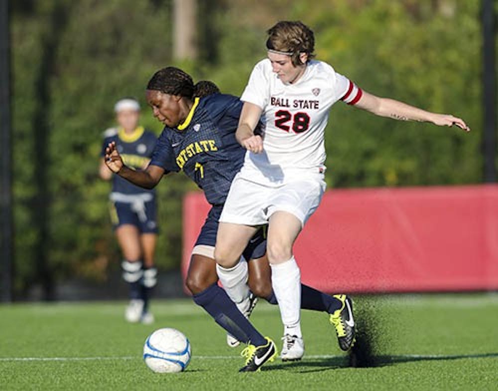Senior midfielder Maimee Morris tries to keep possession of the ball during a drive as Kent State's Katherine Lawrence tries to steal. Ball State lost 1-0. DN PHOTO COREY OHLENKAMP