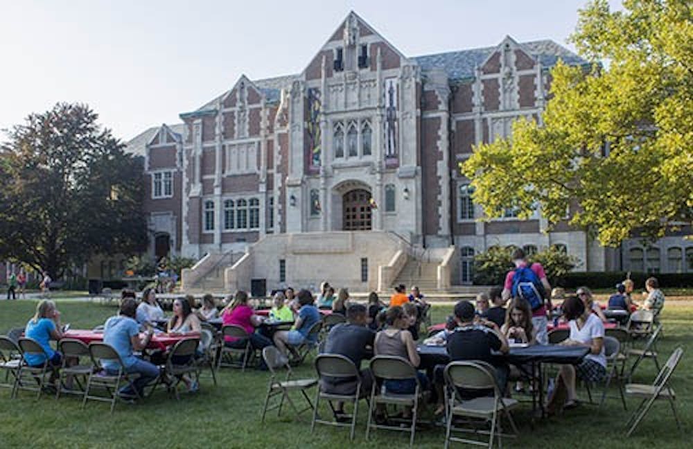 Students sit in the quad in front of the Fine Arts building during the University Program Board Quad Bash on Friday. DN PHOTO TAYLOR IRBY