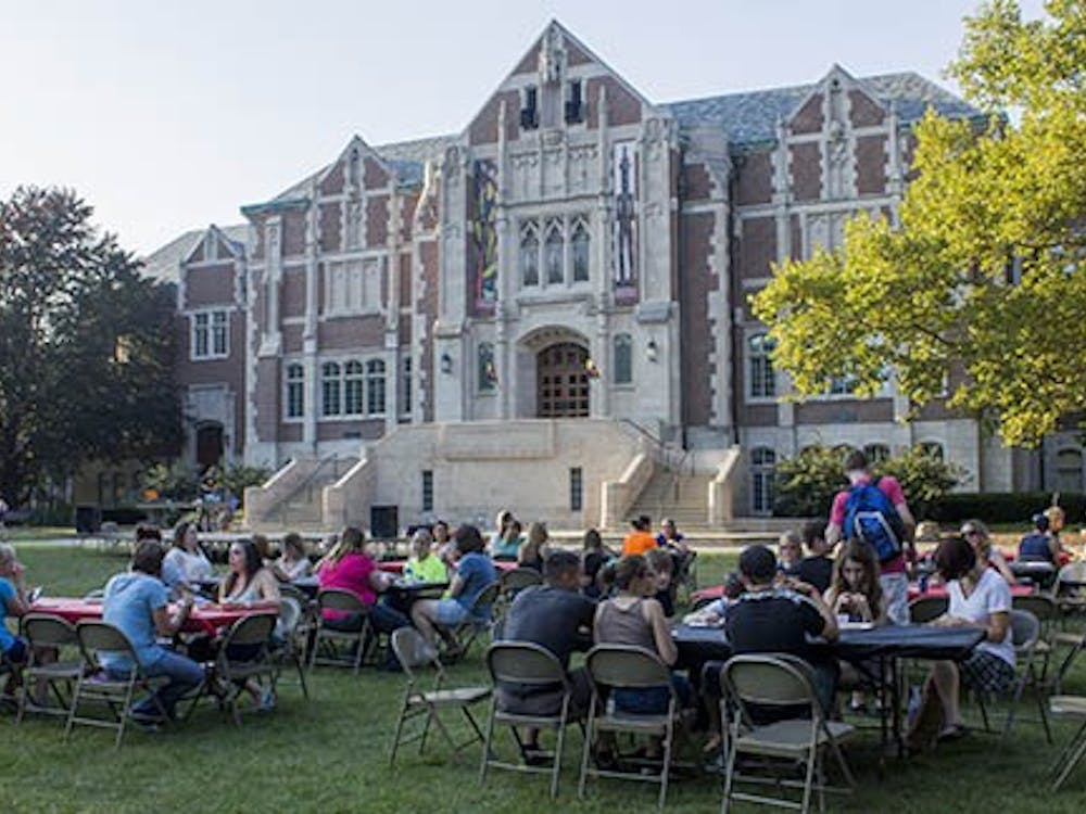 Students sit in the quad in front of the Fine Arts building during the University Program Board Quad Bash on Friday. DN PHOTO TAYLOR IRBY