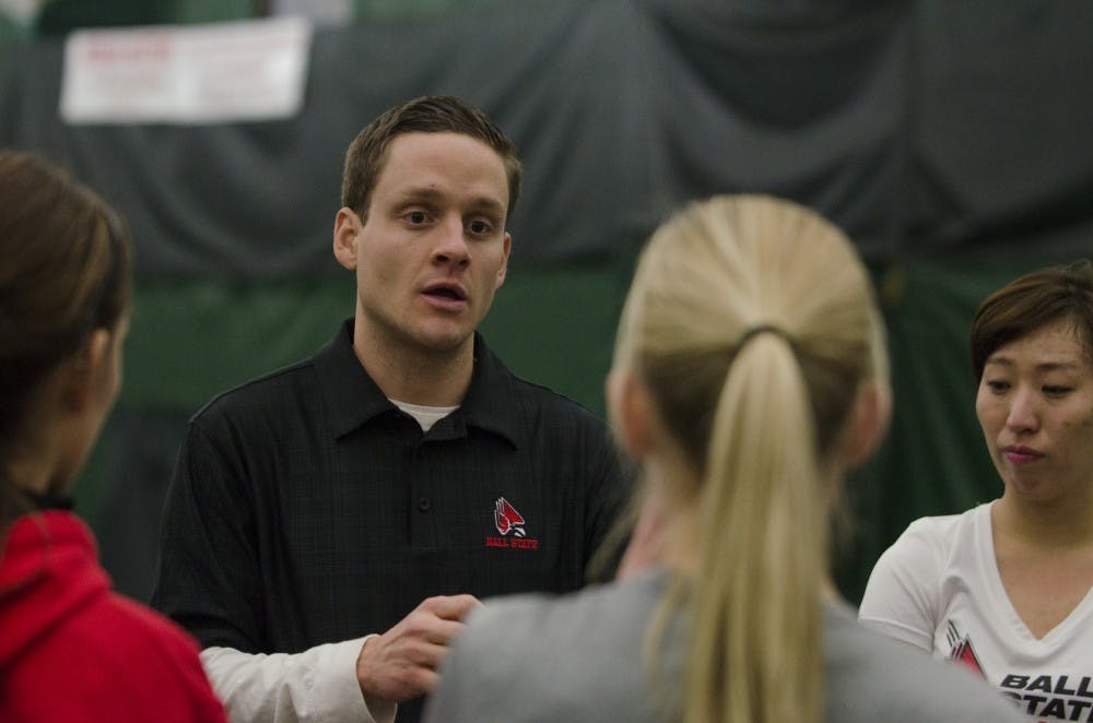 Head coach Max Norris talks to players after finishing their doubles matches Jan. 17 at the YMCA. This is Norris's first year. DN PHOTO BREANNA DAUGHERTY 