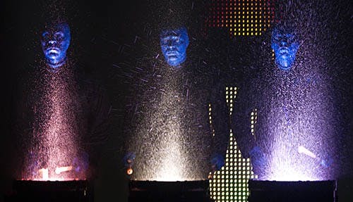 Water flies as the actors perform a “drum blast” during the encore. The Blue Man Group will perform tonight at 7:30 in John R. Emens Auditorium. DN PHOTO BOBBY ELLIS