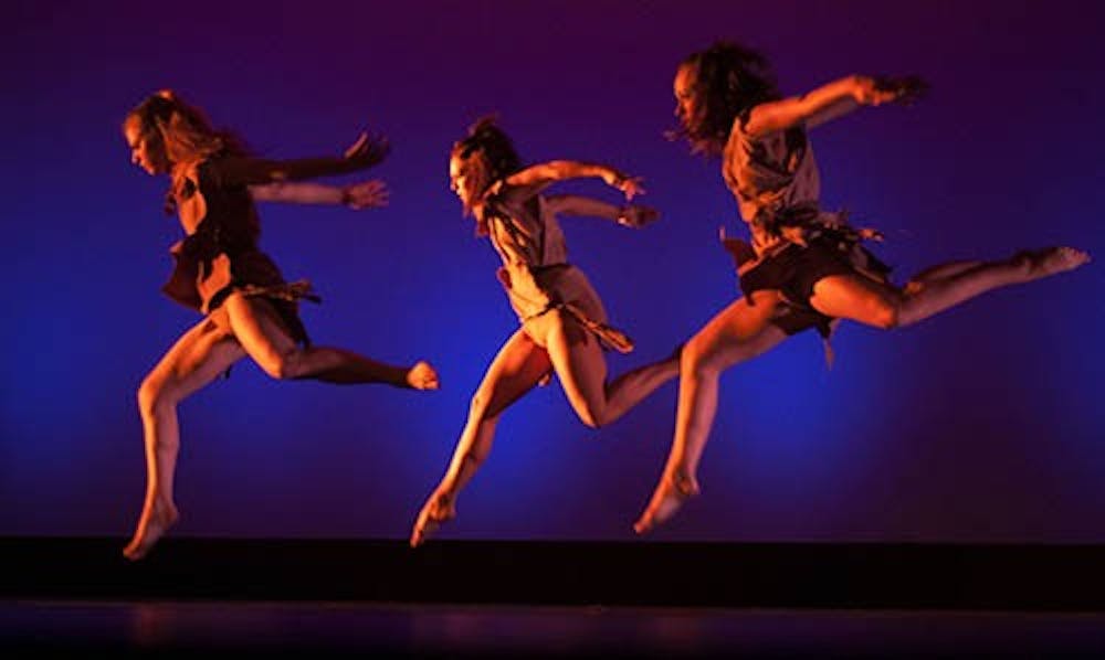 Michele Mackowika, Mollie Craun and Halie Garden leap in the air as part of the final dance, Prey, during Ball State Dance Theatre's "On the Move". DN PHOTO RJ RICKER
