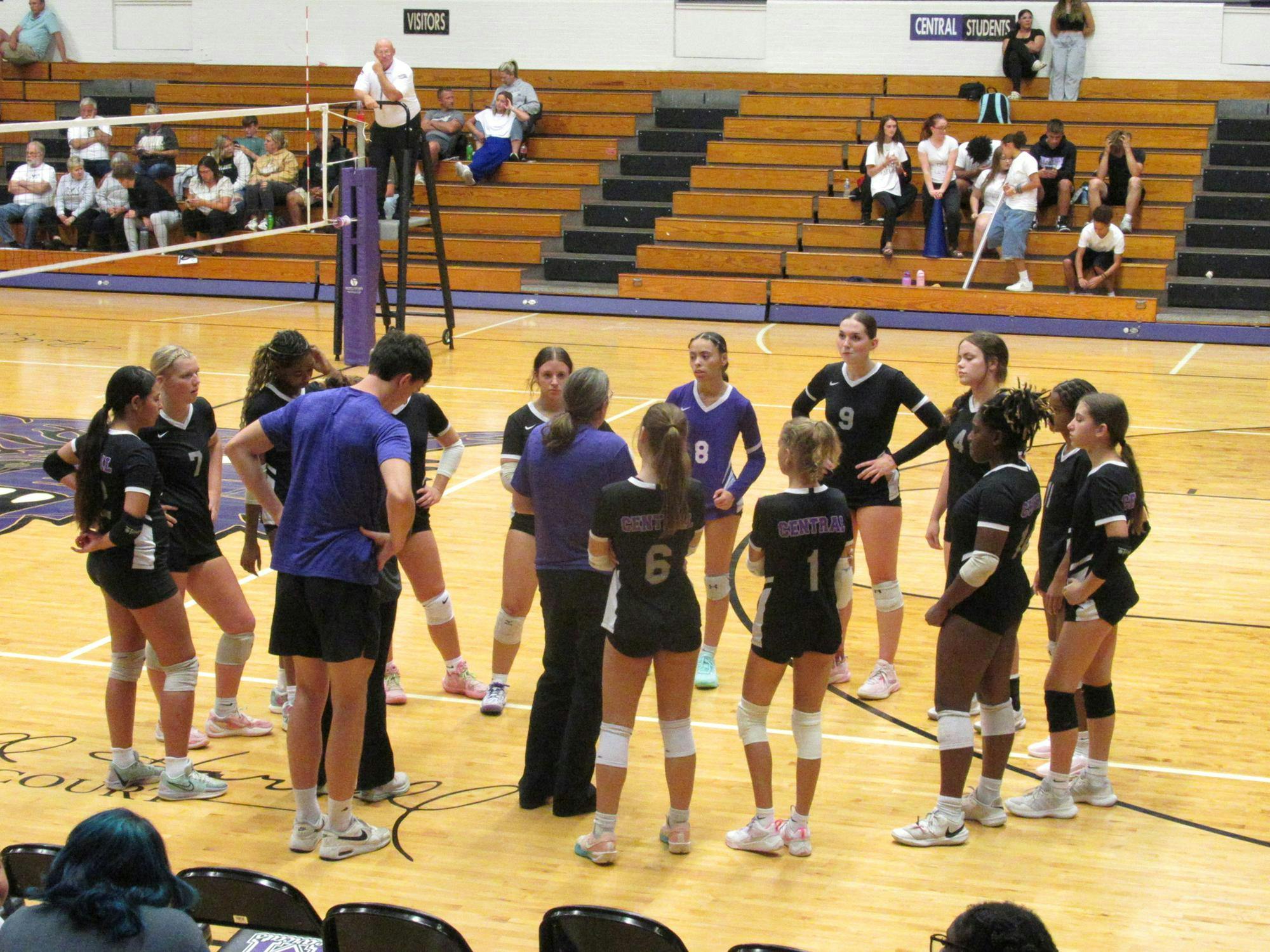 The Lady Bearcats call a tense time-out after a back-and-forth scoring second set during a game against the Madison-Grant Argylls at the Muncie Fieldhouse on Aug. 26. Photo by Madison Ward.