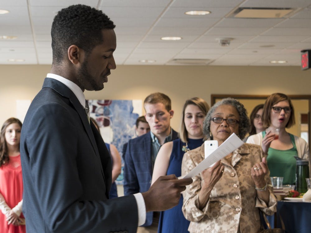 Incoming President James Wells gives his speech after inauguration in the Arts Terrace at the  L.A. Pittenger Student Center Cardinal Hall C on April 20. His grandmother, Ruby  Barnes, video tapes his speech. DN PHOTO STEPHANIE AMADOR