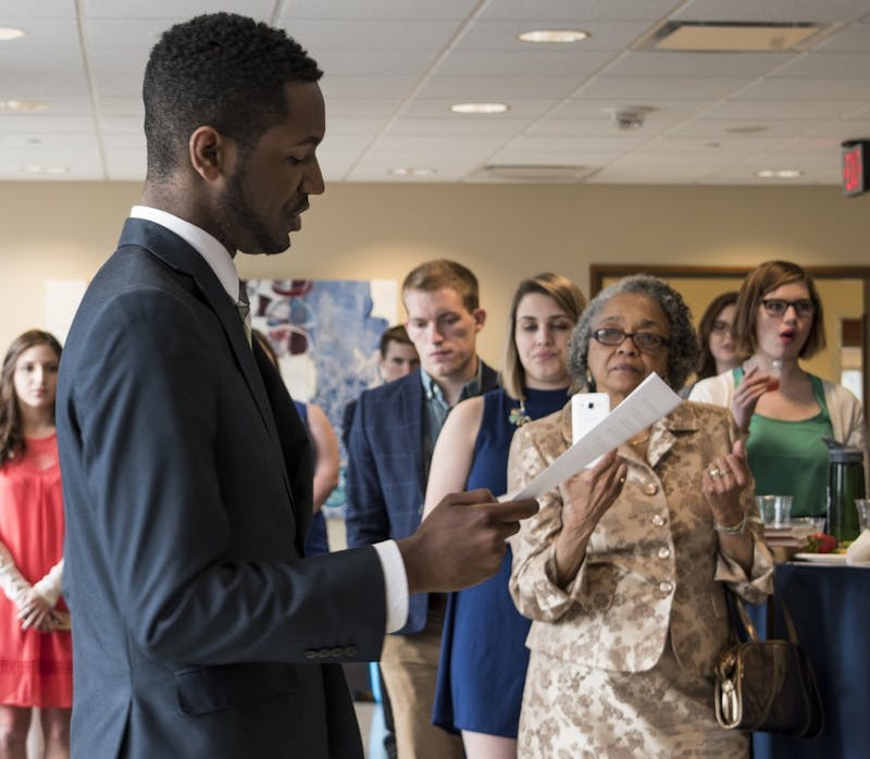 Incoming President James Wells gives his speech after inauguration in the Arts Terrace at the  L.A. Pittenger Student Center Cardinal Hall C on April 20. His grandmother, Ruby  Barnes, video tapes his speech. DN PHOTO STEPHANIE AMADOR