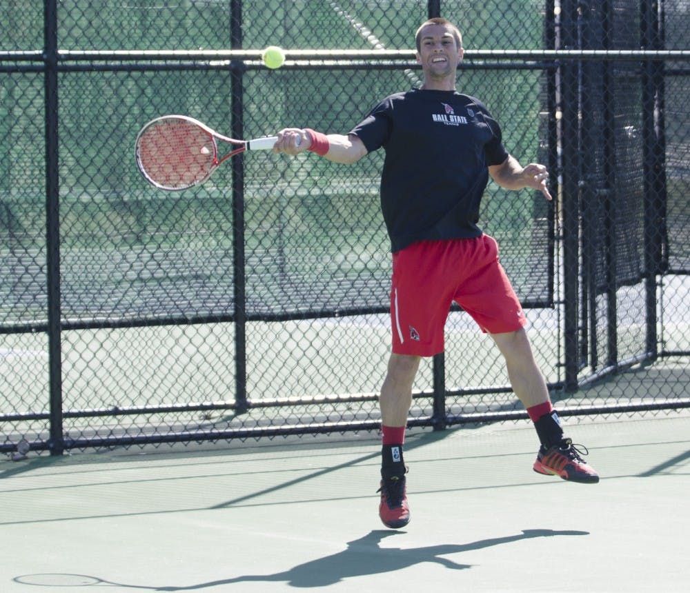 Senior Austin Smith returns the ball to his Toledo opponent on March 30 at the Cardinal Creek Tennis Courts. DN PHOTO BREANNA DAUGHERTY