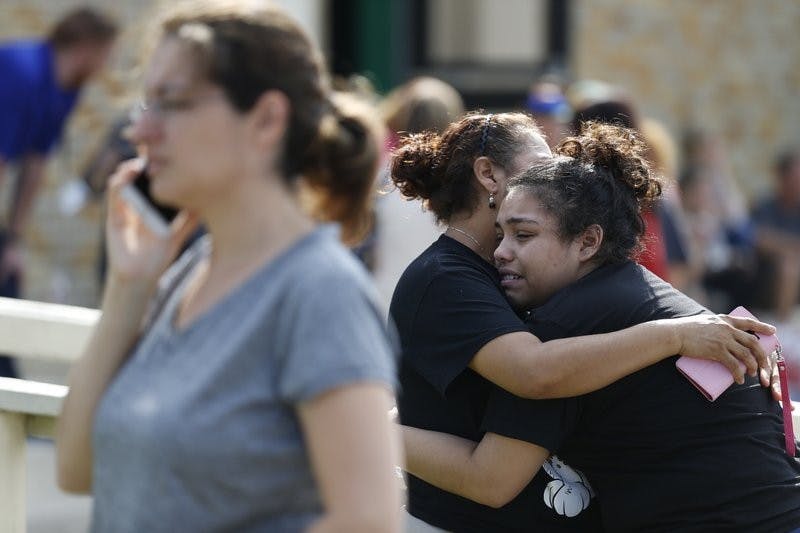 Santa Fe High School junior Guadalupe Sanchez, 16, cries in the arms of her mother, Elida Sanchez, after reuniting with her at a meeting point at a nearby Alamo Gym fitness center following a shooting at Santa Fe High School in Santa Fe, Texas, on Friday, May 18, 2018. AP Photo