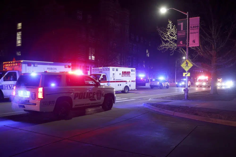 First responders stage outside Berkey Hall on the campus of Michigan State University, late Monday, Feb. 13, 2023, in East Lansing, Mich. (AP Photo/Al Goldis)