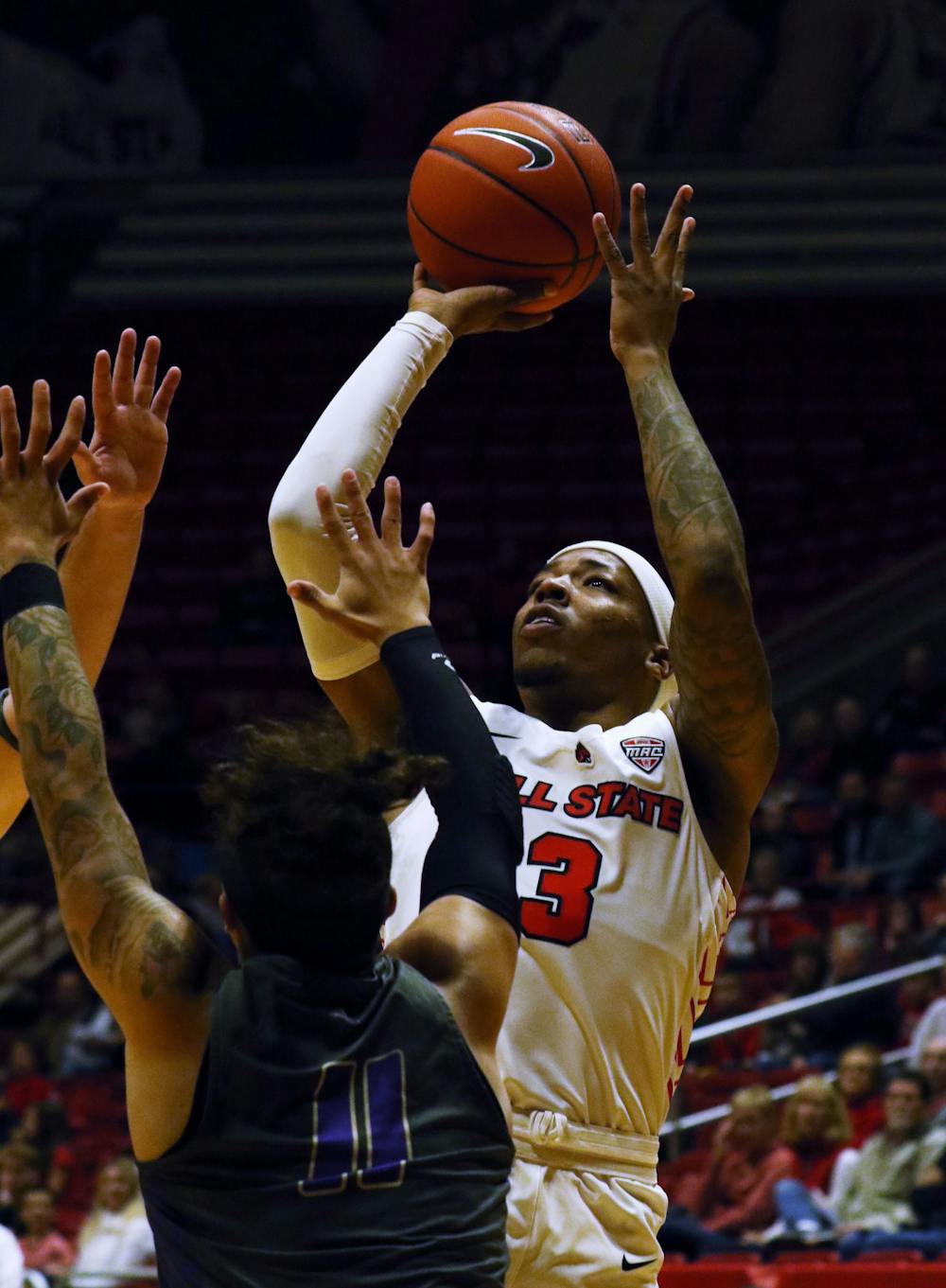 Ball State redshirt senior guard Josh Thompson shoots over the top of Defiance sophomore guard Sean Tyson during the Cardinals' game against the Yellow Jackets Tuesday, Nov. 5, 2019 at John E. Worthen Arena. Thompson scored four points. Paige Grider, DN