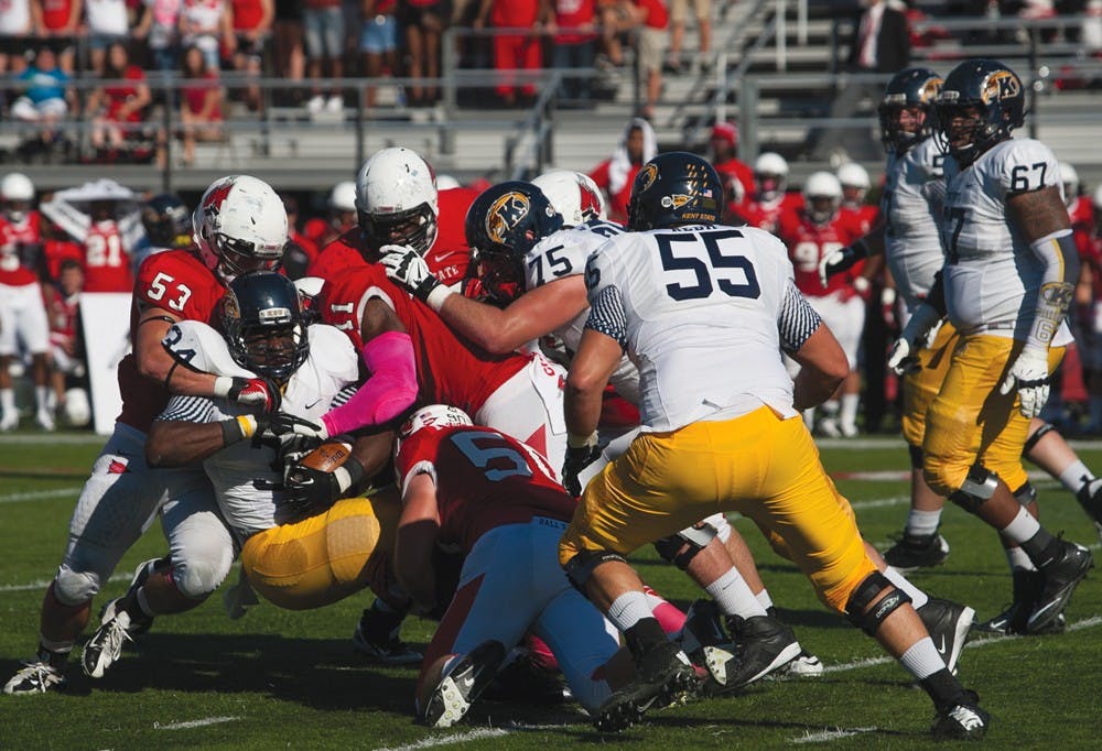Ball State's defense wraps up the ball carrier against Kent State. The defense will need to force turnovers to win against Western Michigan during the game Oct. 19. DN PHOTO JORDAN HUFFER