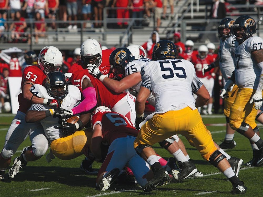 Ball State's defense wraps up the ball carrier against Kent State. The defense will need to force turnovers to win against Western Michigan during the game Oct. 19. DN PHOTO JORDAN HUFFER