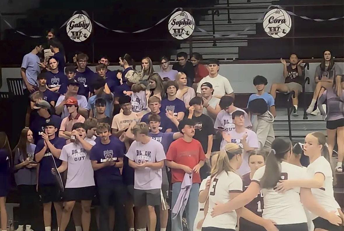Student section showing support to Coach Van Matre by wearing purple during team huddle. PHOTO BY XAVIER HARRIS

