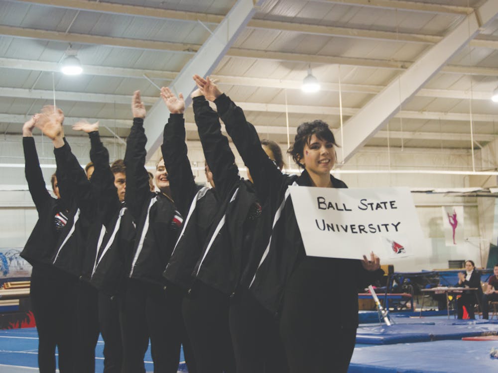 The Ball State Club Gymnastics team salutes the crowd at the inaugural Cardinal Cup on Feb. 2 at Anderson Gymnastics and Cheer. The team practices three times a week in Muncie and Anderson. Jack Williams, DN&nbsp;