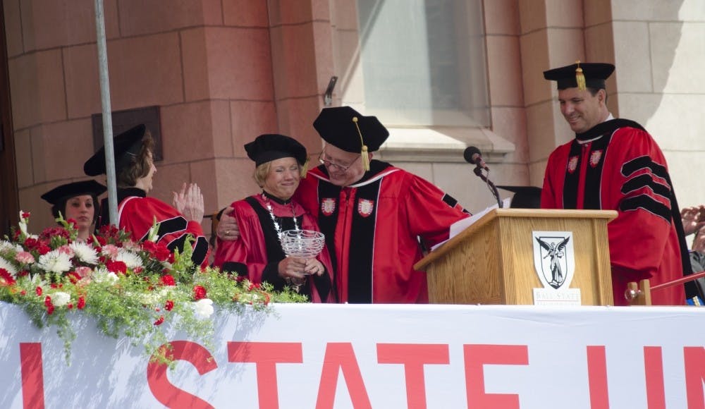 <p>President Jo Ann Gora receives a gift at Spring Commencement on May 3. Later that evening at her retirement celebration, the Board of Trustees announced the renaming of the recreation complex to the Jo Ann Gora Student Recreation and Wellness Center. DN PHOTO BREANNA DAUGHERTY</p>