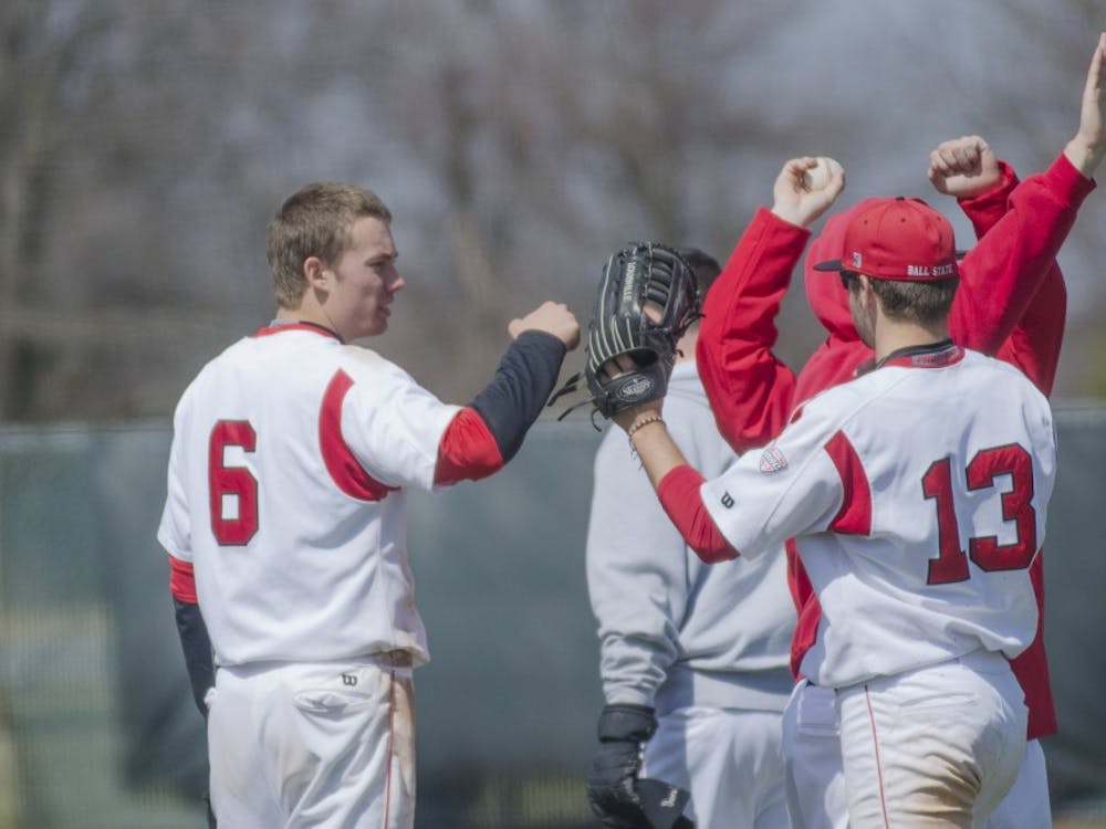 Freshman infielder Alex Maloney celebrates with sophomore outfielder Cole Griesinger after an inning in the game against Eastern Michigan on April 5 at Ball Diamond. DN PHOTO BREANNA DAUGHERTY