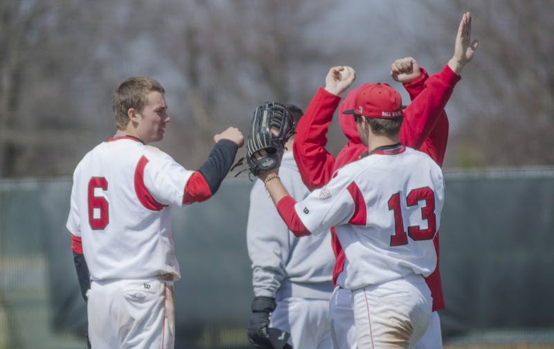 Freshman infielder Alex Maloney celebrates with sophomore outfielder Cole Griesinger after an inning in the game against Eastern Michigan on April 5 at Ball Diamond. DN PHOTO BREANNA DAUGHERTY 