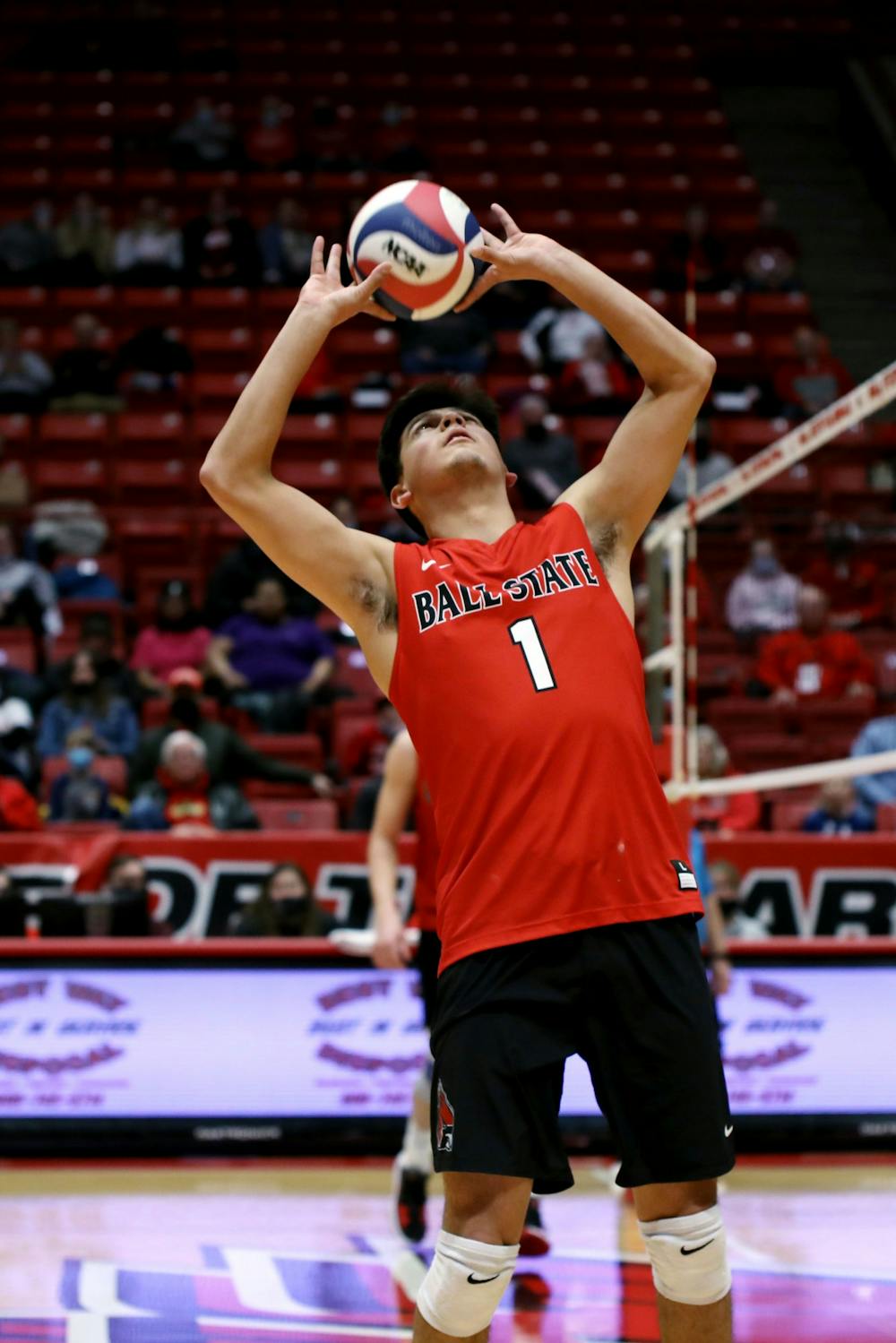 Junior setter David Flores sets the ball to a teammate in a game against Quincy Feb. 25 at Worthen Arena. Flores had 34 assists during the game. Amber Pietz, DN
