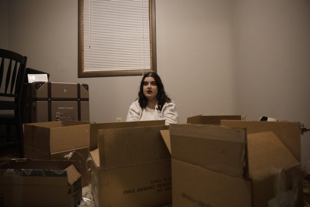 Elena Stidham sits in her apartment surrounded by boxes Feb. 25, 2020, in Muncie, Indiana. Stidham recently moved to her new apartment after leaving her last apartment. Jacob Musselman, DN