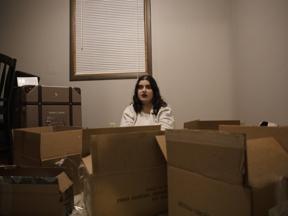 Elena Stidham sits in her apartment surrounded by boxes Feb. 25, 2020, in Muncie, Indiana. Stidham recently moved to her new apartment after leaving her last apartment. Jacob Musselman, DN