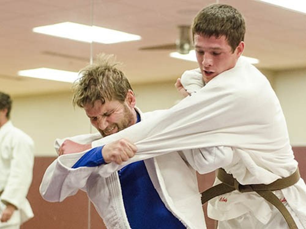 Guest instructor Brad Daniels throws student and club member Caleb Culy in an exercise called Nage komi, an exercise on repeated throws. Two novice members earned third place in the Women’s Novice Team category at the National Collegiate Judo Tournament in Iowa over the weekend. DN PHOTO COREY OHLENKAMP