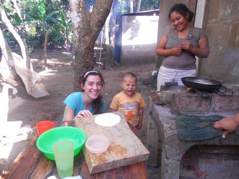 Bailey Shannon (left) makes quesadillas with Masatepe local Maria, 18, in her backyard kitchen with her 3-year-old nephew Harit. Shannon spent 18 days with the locals of Masatepe for a mission trip with the BridgeWay Community Church. PHOTO PROVIDED BY BAILEY SHANNON