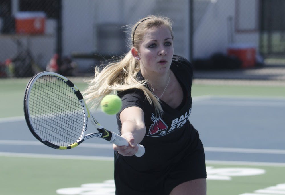 Senior Kristel Sanders reaches to hit the ball in her doubles match against Northern Illinois on March 21. Sanders, from Veldhoven, Netherlands, plays both doubles and singles. DN FILE PHOTO BREANNA DAUGHERTY