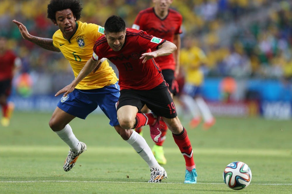 Marcello of Brazil vies with Oribe Peralta of Mexico during the World Cup pn Tuesday, June 17, 2014, in Fortaleza, Brazil. (Imago/Zuma Press/MCT)