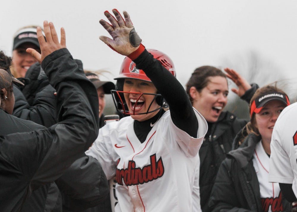 Freshman Katie Janiga high fives her teammates in celebrating the last hit during the game. The Ball State Cardinals won against Kent State with a score of 15-7 at the Softball Field at First Merchants Ballpark Complex on April 6. Carlee Ellison, DN