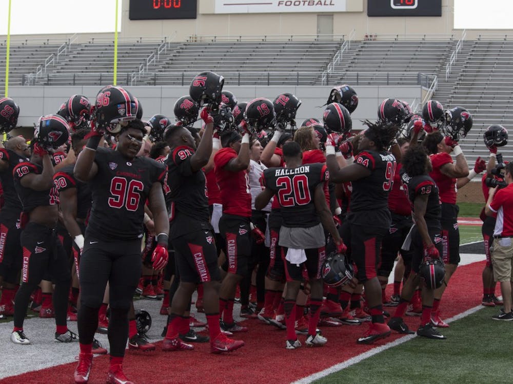 The Ball State football team raises their helmets and sings the school’s fight song after their spring game at Scheumann Stadium on April 15. The game marked the end of the team’s spring practices. Briana Hale // DN
