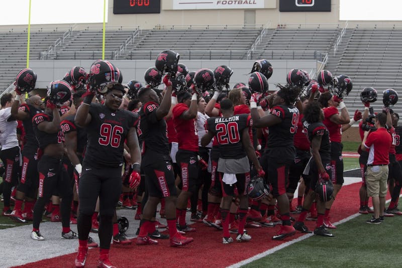 The Ball State football team raises their helmets and sings the school’s fight song after their spring game at Scheumann Stadium on April 15. The game marked the end of the team’s spring practices. Briana Hale // DN