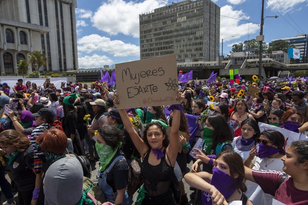 Women march in front of the Supreme Court during International Women's Day March 8, 2020, in Guatemala City. (AP Photo/Moises Castillo)