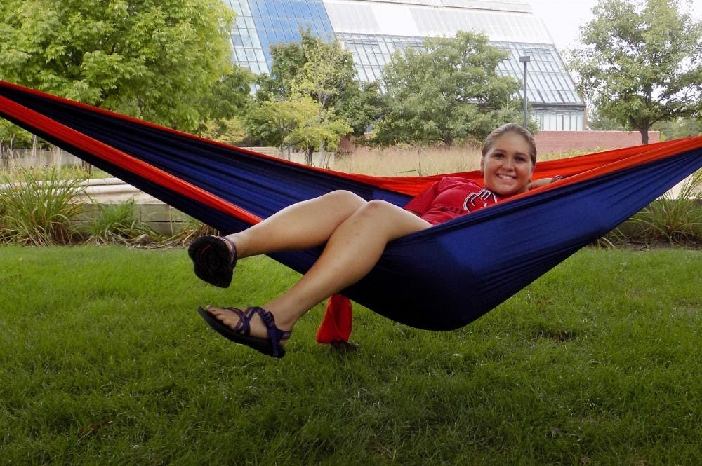 Haleigh Pickett, a freshman sports administration major, relaxes in her hammock in the lawn by Frog Baby. Hammocking is a growing trend on the Ball State campus and is a way for students to relax and get outside. Mary Freda // DN