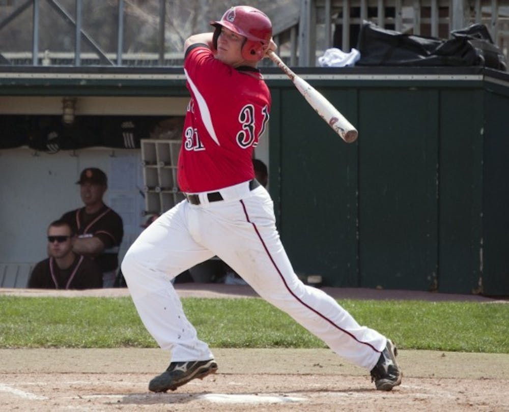 Freshman first baseman Kenny Mahala watches as his second grand slam in consecutive innings goes over the fence against Bowling Green Sunday afternoon. The Cardinals and Eagles split the doubleheader, but Bowling Green went on to win the series. DN PHOTO DYLAN BUELL