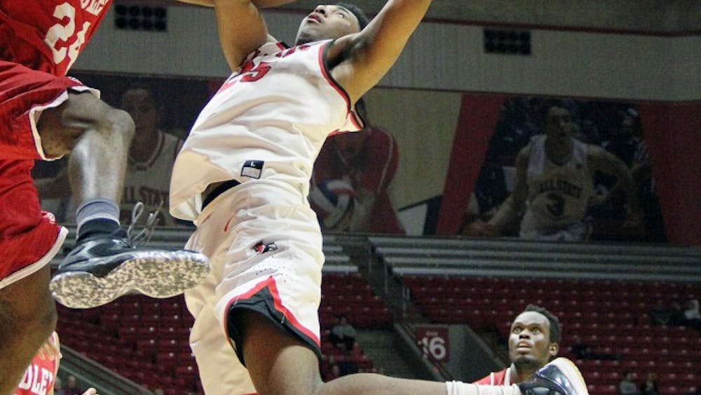 Forward Tahjai Teague goes up for a shot and is defended by Bradley