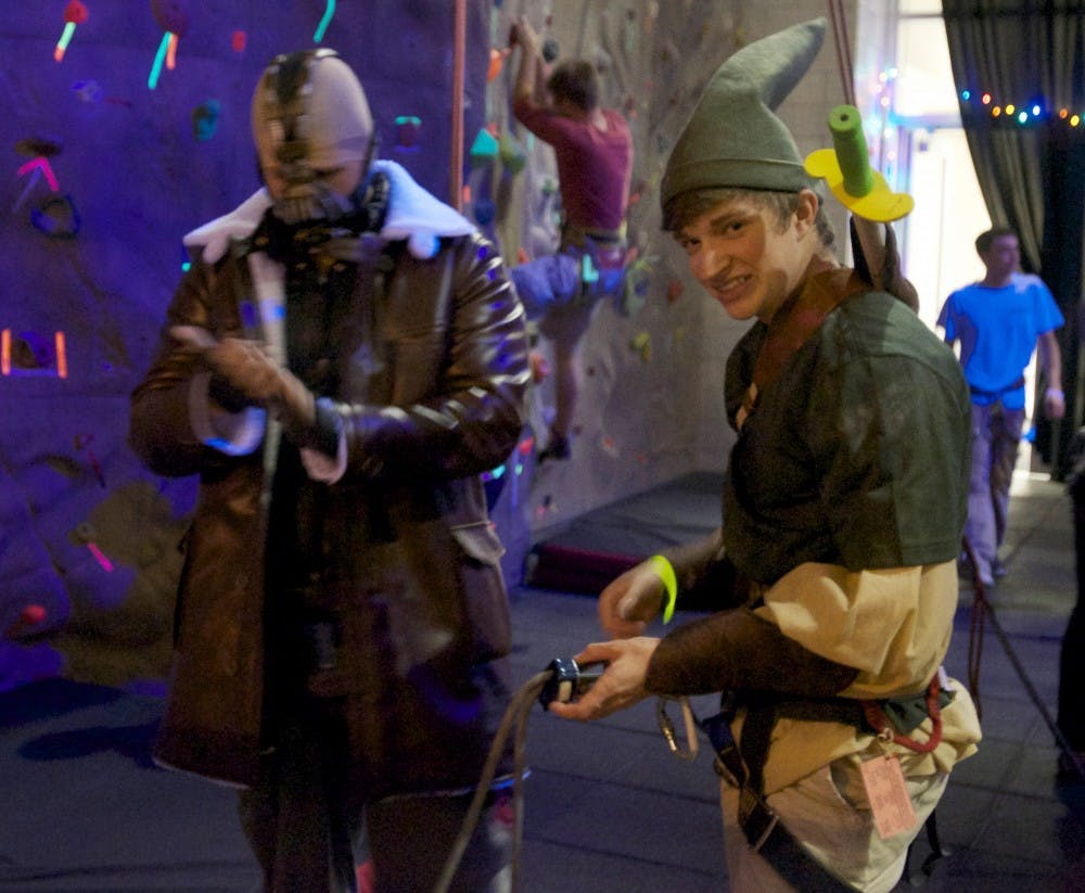 A Ball State freshman helps a friend during Heights and Frights at the Student Wellness and Recreation Center on Oct. 30. The event had free blacklight climbing with music, door prizes and a costume contest. DN PHOTO MARCEY BURTON