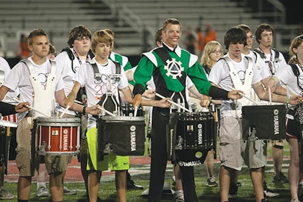 Members of the Music For All drumline perform with drummers from The Cavaliers. They arranged their piece specifically for this event. DN PHOTO JORDAN HUFFER