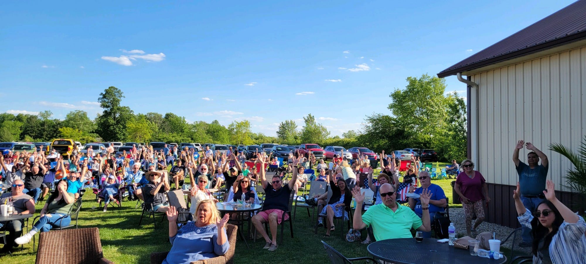 Attendees of Tonne Winery's Tonne Music Series celebrate their night in Muncie, Indiana in 2022. The Tonne Music Series is a weekly event that showcases local music, along with food trucks and products courtesy of the winery. (Sara Rogers)