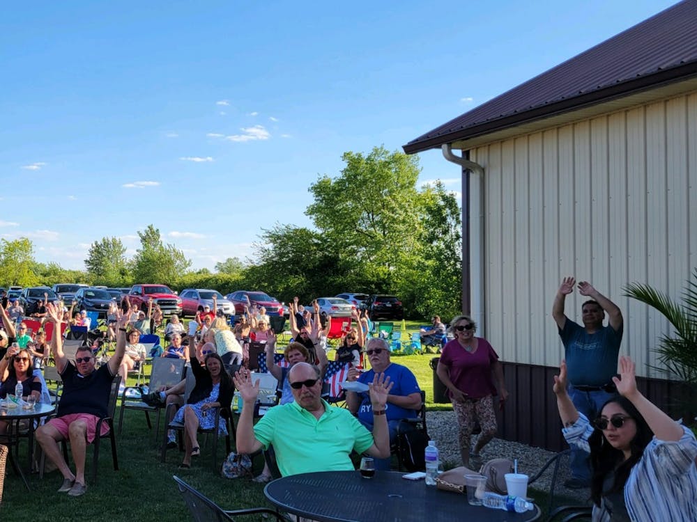Attendees of Tonne Winery's Tonne Music Series celebrate their night in Muncie, Indiana in 2022. The Tonne Music Series is a weekly event that showcases local music, along with food trucks and products courtesy of the winery. (Sara Rogers)