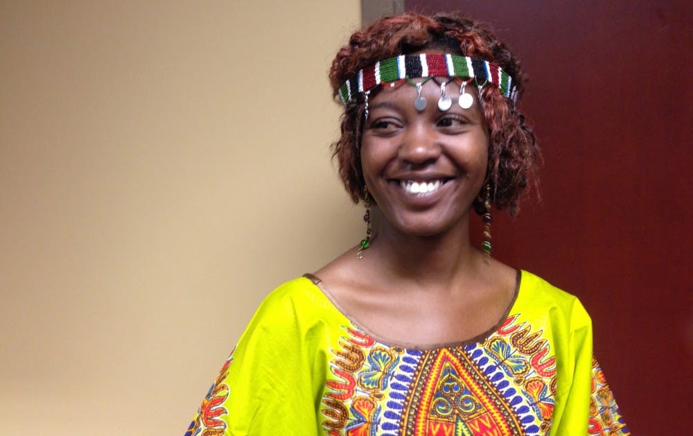 Porine Ayogi, a graduate student in sociology from Kenya, wears a kitenge at her booth at The Amazing Taste. DN PHOTO JEREMY ERVIN