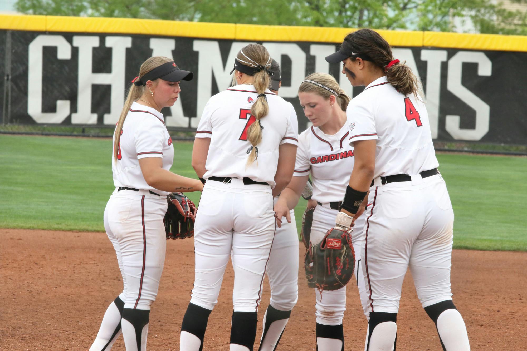 Multiple Ball State players huddle on the pitching mound during the Mid-American Conference (MAC) Tournament May 12 at Miami University. Zach Carter, DN