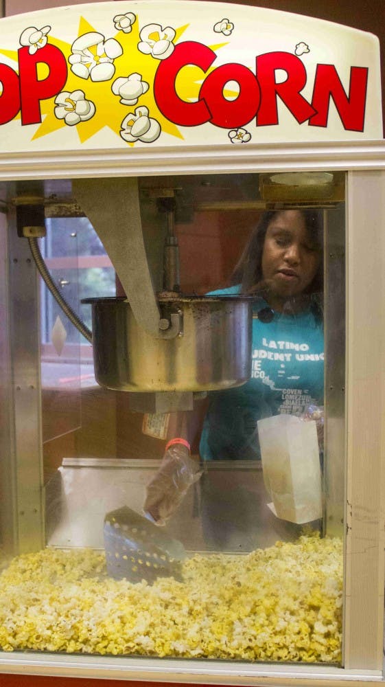 Ariel Garza a sophomore journalism student bags popcorn at the Fiesta hosted by the Latino Student Union and UPB in the Student Center on Friday evening. DN PHOTO TAYLOR IRBY 