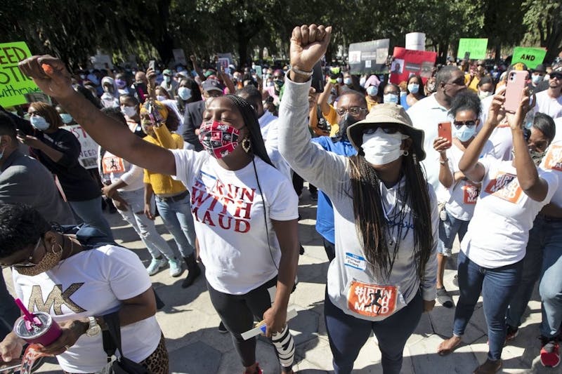 People react during a rally to protest the shooting of Ahmaud Arbery, May 8, 2020, in Brunswick Ga. Two men have been charged with murder in the February shooting death of Arbery, a black man in his mid-20s, whom they had pursued in a truck after spotting him running in their neighborhood. (AP Photo/John Bazemore)