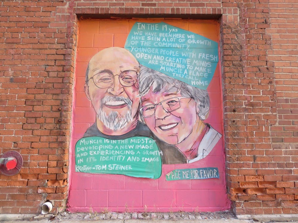 A mural in Downtown Muncie shows a man and woman discussing their love for Muncie. Blake Williamson, DN.