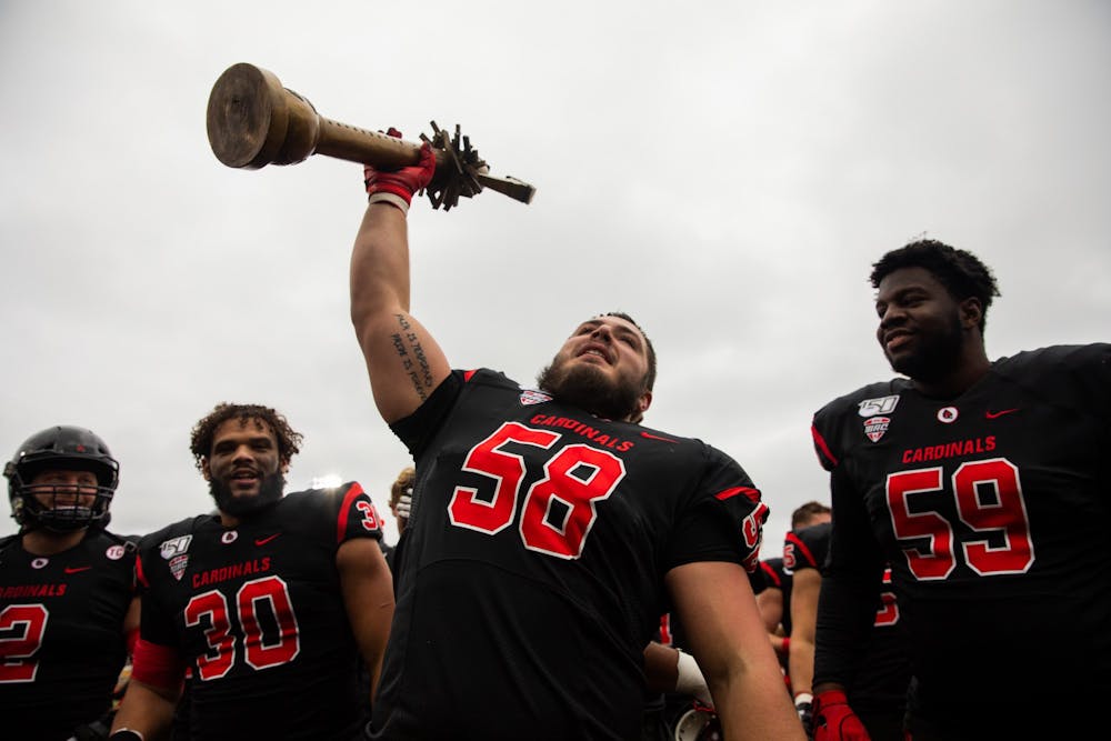 <p>Senior defensive tackle Chris Crumb holds up the Red Bird Rivalry Trophy after beating Miami (Ohio) Nov. 29, 2019, at Scheumann Stadium. The Cardinals beat the Red Hawks, 41-27. <strong>Jacob Musselman, DN</strong></p>
