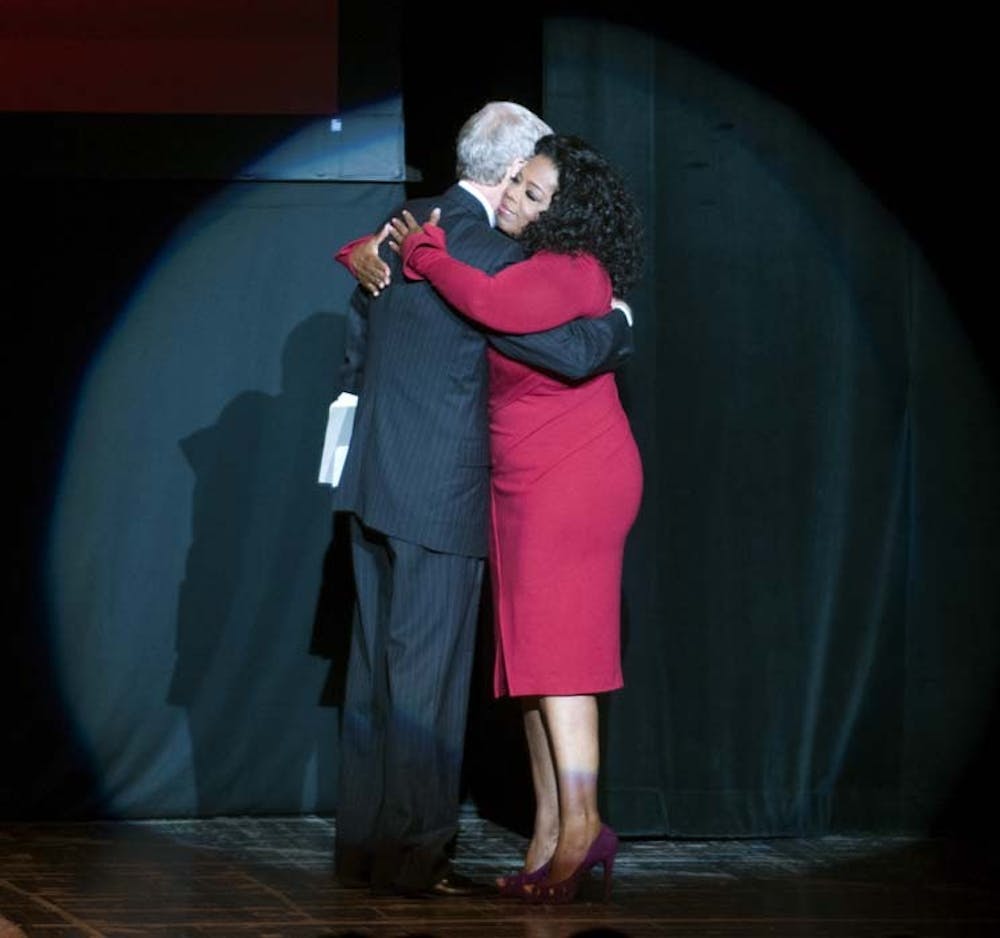 Dave and Oprah embrace before their talk. DN PHOTO BOBBY ELLIS