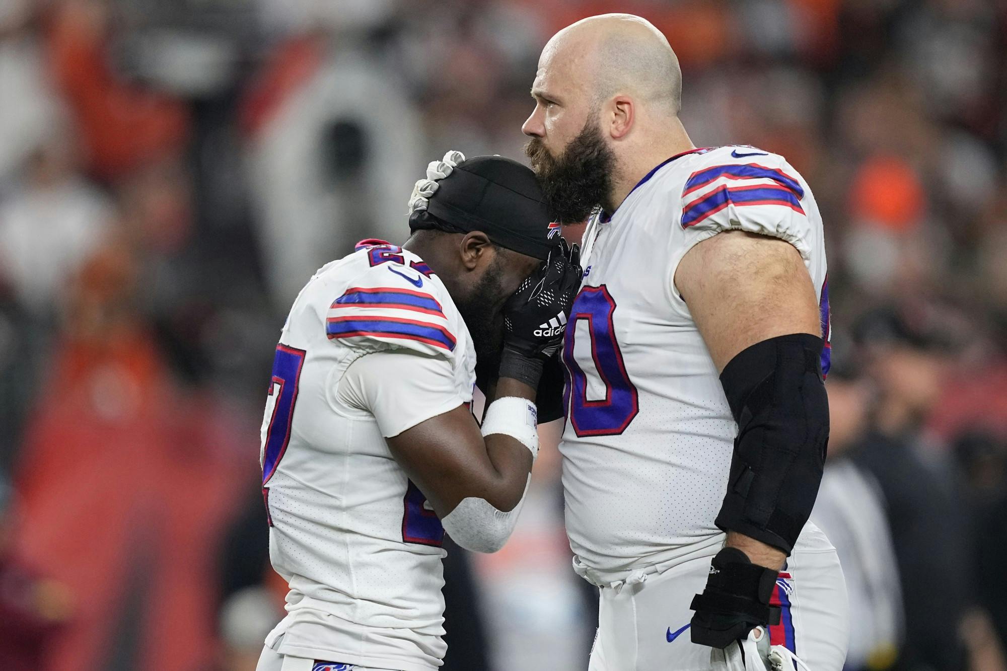 Tre'Davious White (27) and Mitch Morse (60) of the Buffalo Bills react to teammate Damar Hamlin (3) collapsing after making a tackle against the Cincinnati Bengals during the first quarter at Paycor Stadium on Monday, Jan. 2, 2023, in Cincinnati. (Dylan Buell/Getty Images/TNS)