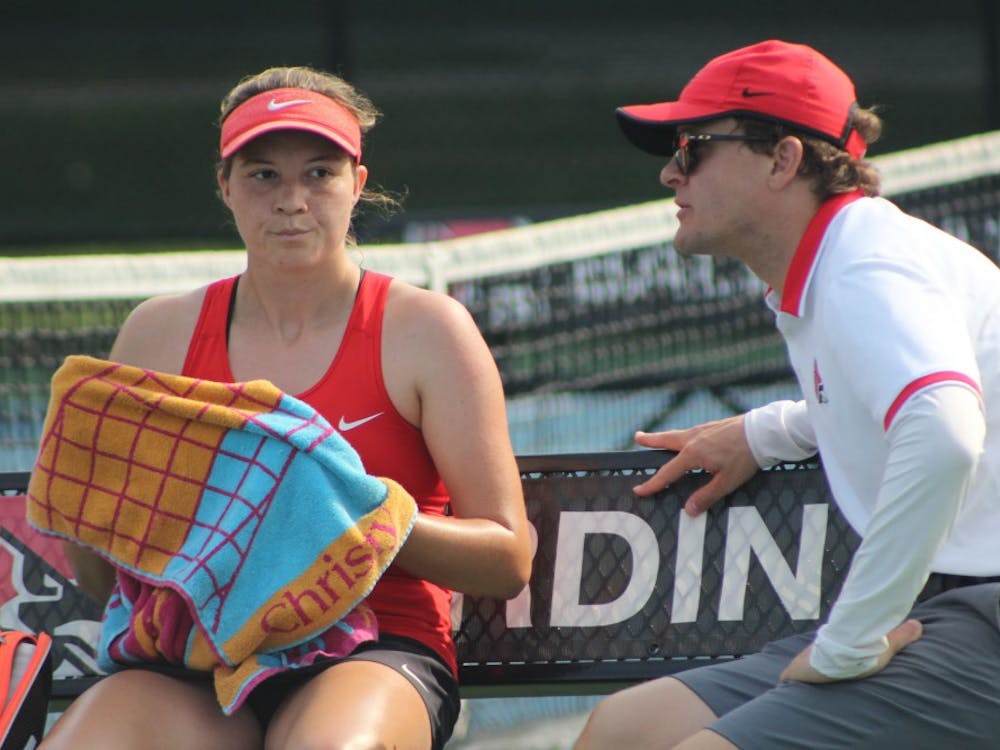 Junior Rebecca Herrington and head coach Max Norris talk to each other a her singles match against Detroit Mercy on the first day of the Hidden Dual tournament. Herrington won her first set, 6-2. Photo by Patrick Murphy