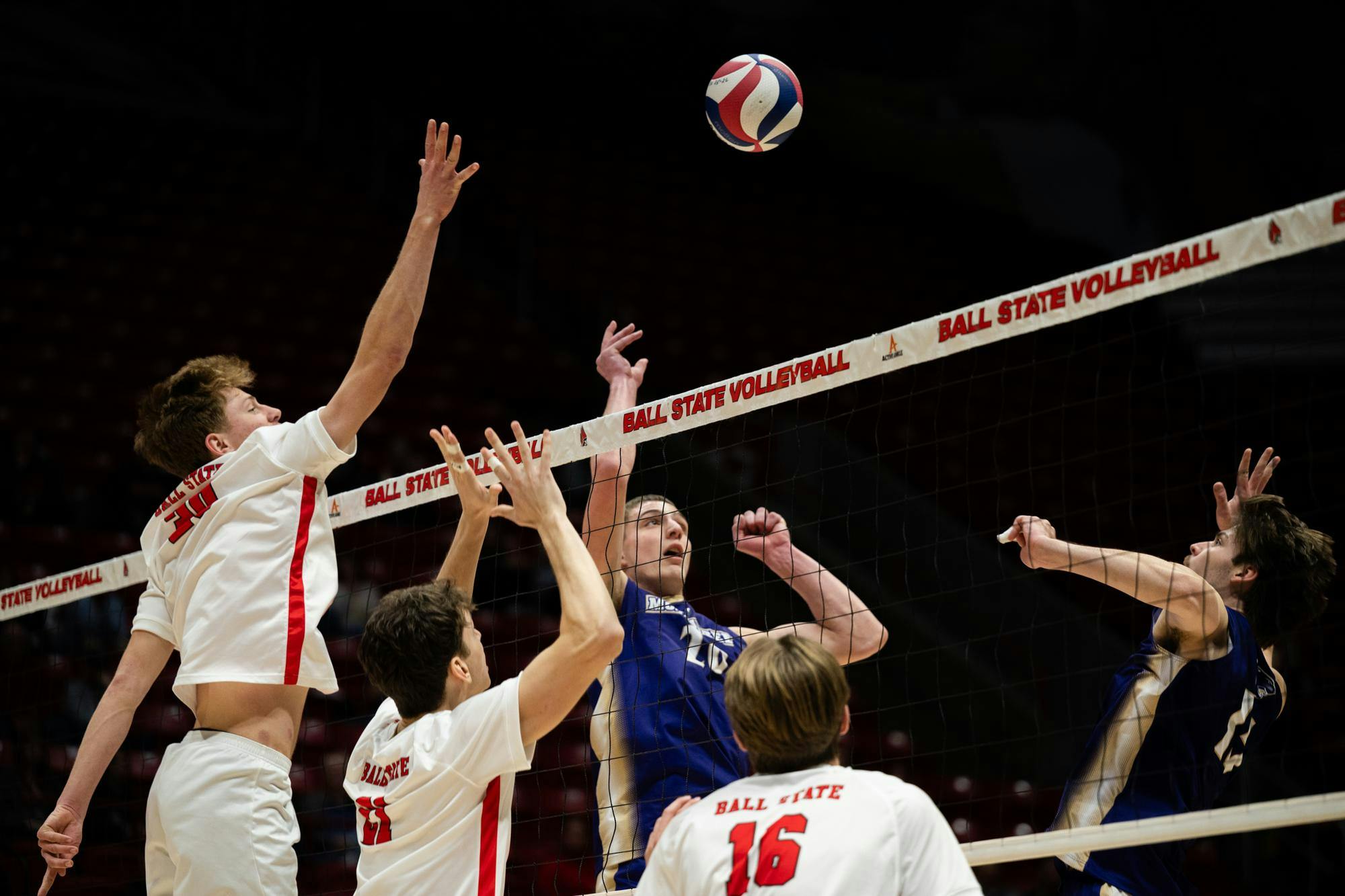 Players from the Ball State and McKendree University leap towards the ball during a mens volleyball match Feb. 12 at Worthen Arena. Ryan Fleek, DN