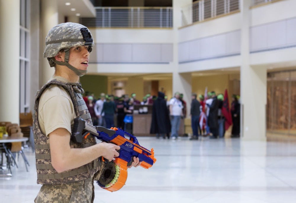 A Ball State student stands in front of a hoard of zombies at the final event of 